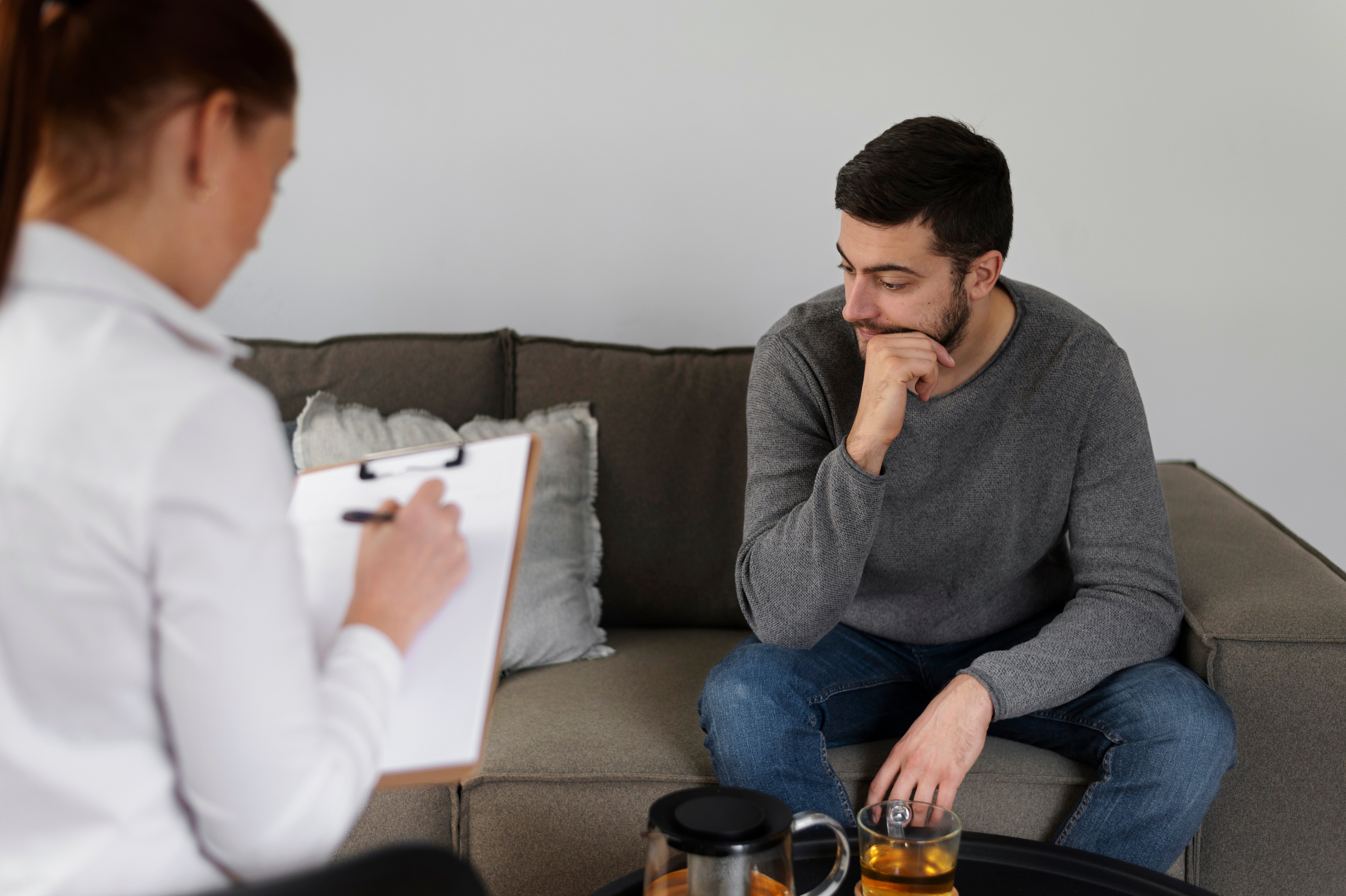 close-up-man-discussing-with-therapist